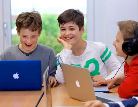 ISHR Middle School students using MacBooks